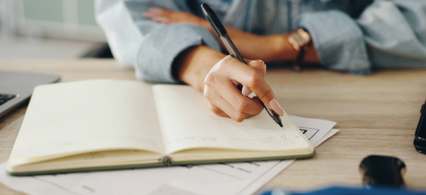 Person organizing financial notes and planning for unexpected expenses in retirement.